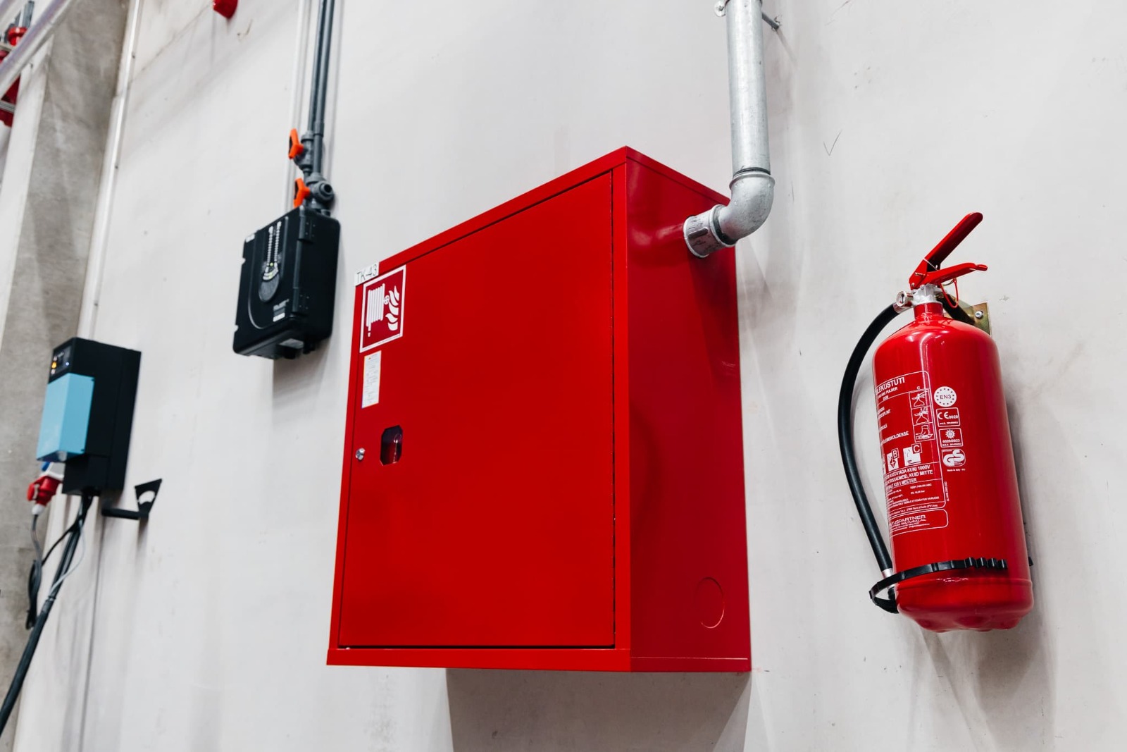 Fire hose cabinet and extinguisher on wall